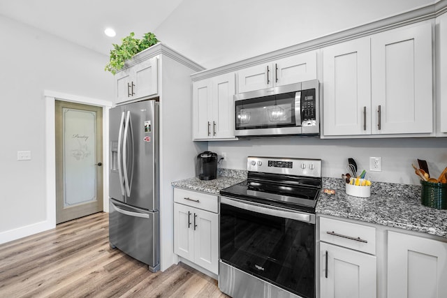 14170 Spring Valley Ct, Niles, MI 49120 - kitchen featuring appliances with stainless steel finishes, light wood-style floors, light stone countertops, and recessed lighting