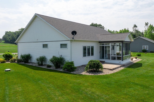 14170 Spring Valley Ct, Niles, MI 49120 - rear view of house featuring a sunroom, roof with shingles, and a yard