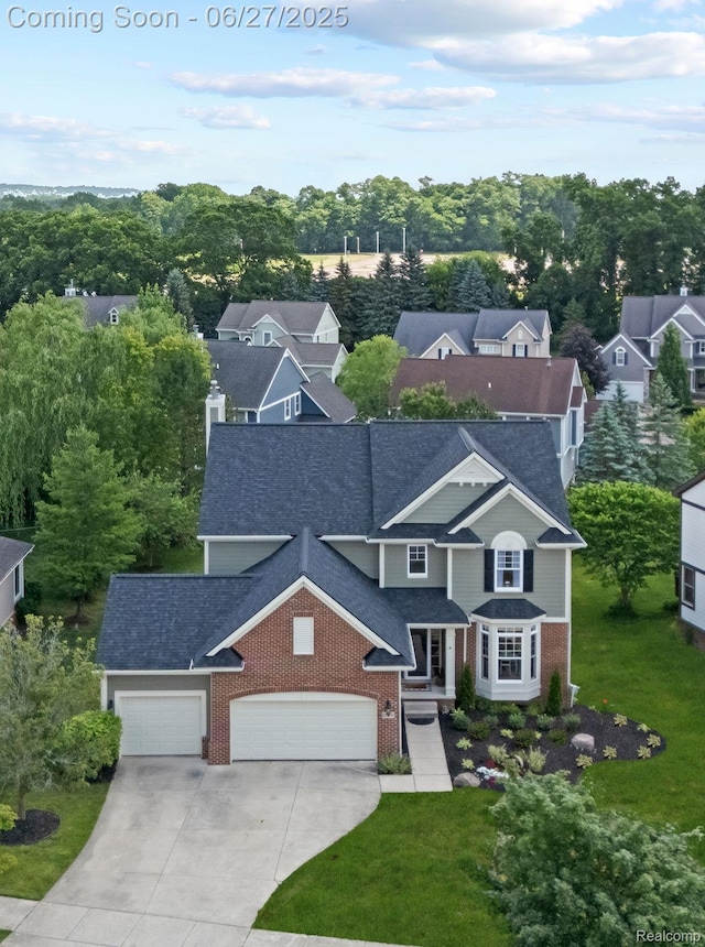 6060 Balmoral Way, Commerce Twp, MI 48382 - view of front of house with an attached garage, brick siding, driveway, and a front lawn