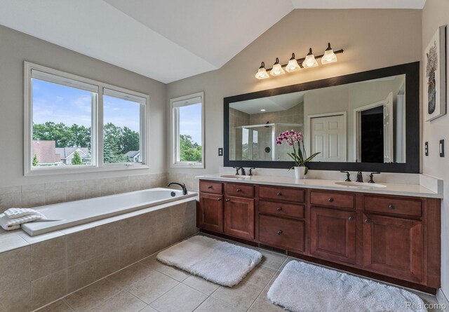 6060 Balmoral Way, Commerce Twp, MI 48382 - full bath featuring double vanity, a shower stall, lofted ceiling, tile patterned flooring, and a bath