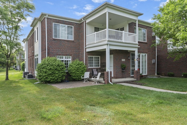 6733 Boulder Pointe Dr, Washington, MI 48094 - view of front facade with a balcony, a front lawn, brick siding, and a patio area