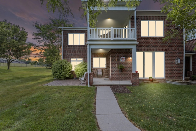 6733 Boulder Pointe Dr, Washington, MI 48094 - view of front of property with a balcony, a front lawn, brick siding, and a patio area