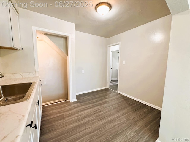 9646 Ward St, Dearborn, MI 48227 - kitchen with dark wood-style flooring, white cabinetry, and light stone countertops