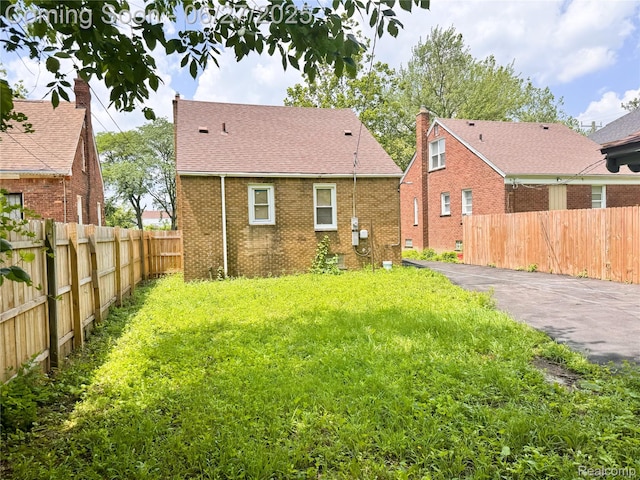 9646 Ward St, Dearborn, MI 48227 - rear view of property with brick siding, driveway, and a shingled roof