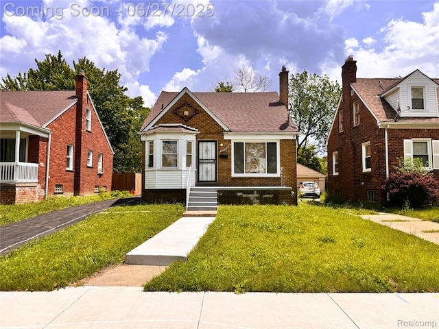 9646 Ward St, Dearborn, MI 48227 - bungalow-style house with a front lawn, brick siding, and a chimney