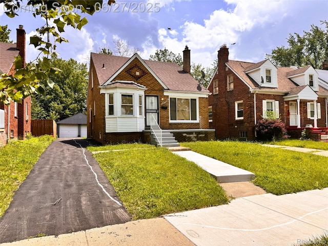 9646 Ward St, Dearborn, MI 48227 - bungalow-style house with brick siding, a garage, a front yard, an outdoor structure, and roof with shingles