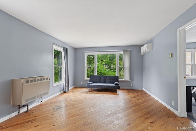 830 College Ave, Adrian, MI 49221 - living area with plenty of natural light, an AC wall unit, and heating unit