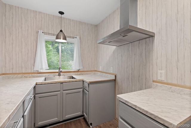 830 College Ave, Adrian, MI 49221 - kitchen with wall chimney range hood, gray cabinetry, light countertops, pendant lighting, and dark wood-style floors