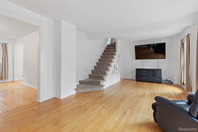 830 College Ave, Adrian, MI 49221 - living room with hardwood / wood-style flooring and stairway
