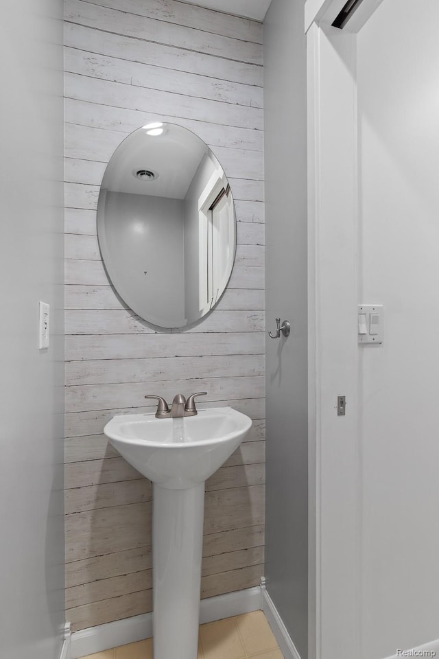 830 College Ave, Adrian, MI 49221 - bathroom featuring wood walls and tile patterned floors