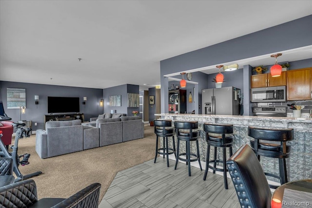1001 W Jefferson Ave Unit 28E, Detroit, MI 48226 - living room featuring light carpet and bar