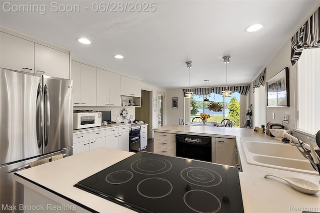 4848 Willow Ln, Orchard Lake, MI 48324 - kitchen with black appliances, recessed lighting, light countertops, pendant lighting, and a peninsula
