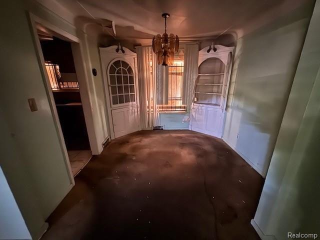 18460 Ferguson St, Detroit, MI 48235 - hallway with unfinished concrete flooring and a chandelier