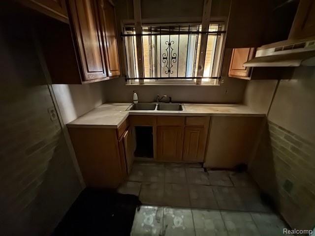 18460 Ferguson St, Detroit, MI 48235 - kitchen with light countertops, brown cabinetry, and light tile patterned flooring