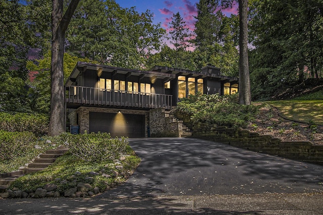 1917 Benjamin Ave, Kalamazoo, MI 49008 - view of front of home with stairs, asphalt driveway, a garage, and stone siding