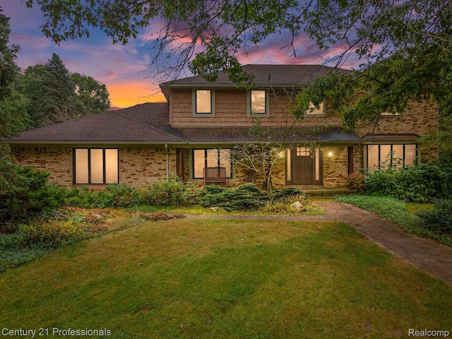 9601 Kier Rd, Holly, MI 48442 - traditional-style house with a front yard, brick siding, and roof with shingles