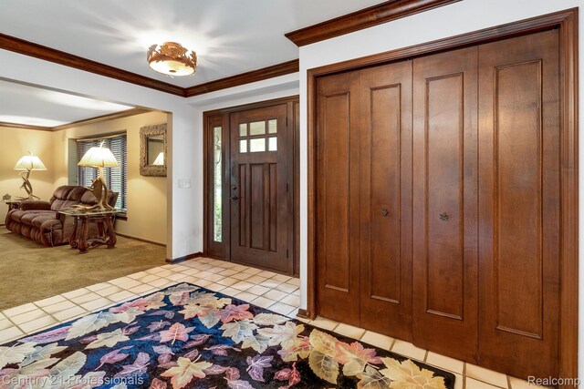 9601 Kier Rd, Holly, MI 48442 - foyer with light tile patterned floors, light colored carpet, and ornamental molding
