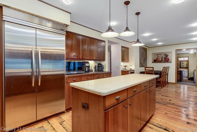 9601 Kier Rd, Holly, MI 48442 - kitchen with stainless steel built in fridge, light wood finished floors, a kitchen island, light countertops, and hanging light fixtures