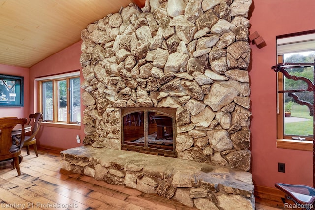 9601 Kier Rd, Holly, MI 48442 - unfurnished living room with hardwood / wood-style flooring, lofted ceiling, a stone fireplace, and wood ceiling