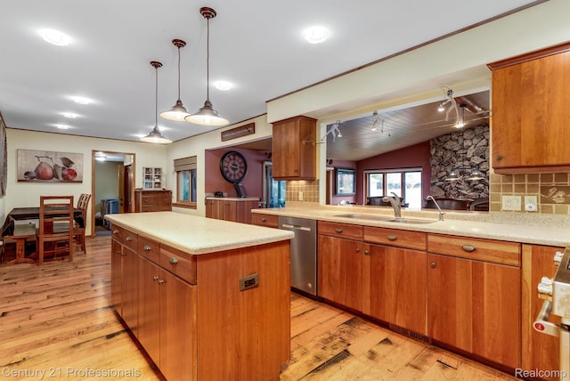 9601 Kier Rd, Holly, MI 48442 - kitchen featuring dishwasher, vaulted ceiling, a kitchen island, light wood-style flooring, and backsplash