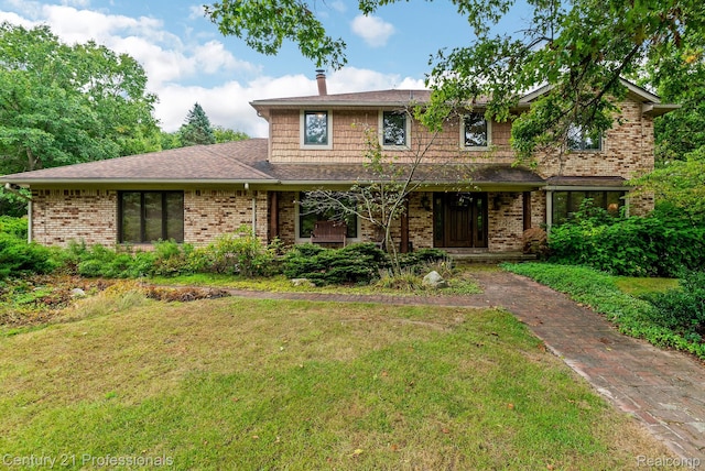 9601 Kier Rd, Holly, MI 48442 - traditional home with a front yard, brick siding, and roof with shingles