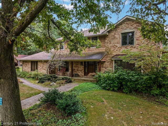 9601 Kier Rd, Holly, MI 48442 - view of front facade with covered porch, brick siding, and a front yard