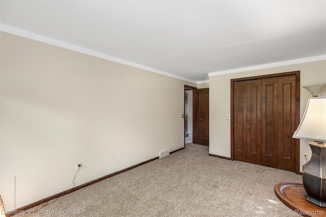 9601 Kier Rd, Holly, MI 48442 - unfurnished bedroom with light carpet, a closet, and ornamental molding