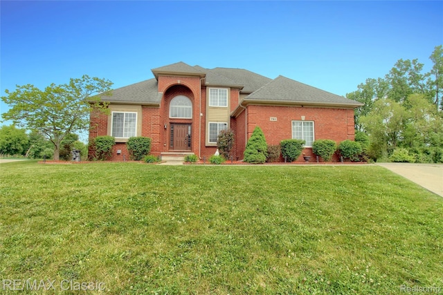 761 Nissen Ct, Wixom, MI 48393 - traditional-style house featuring brick siding, a front yard, and roof with shingles