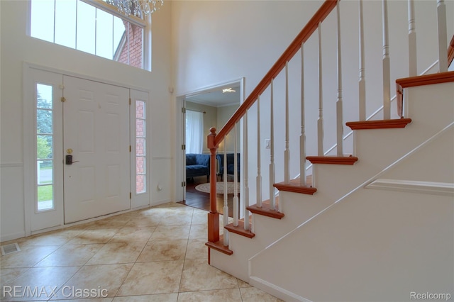761 Nissen Ct, Wixom, MI 48393 - tiled entryway with stairway and a towering ceiling