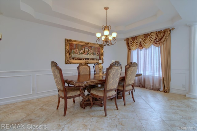 761 Nissen Ct, Wixom, MI 48393 - dining space with a decorative wall, a raised ceiling, a chandelier, wainscoting, and light tile patterned flooring