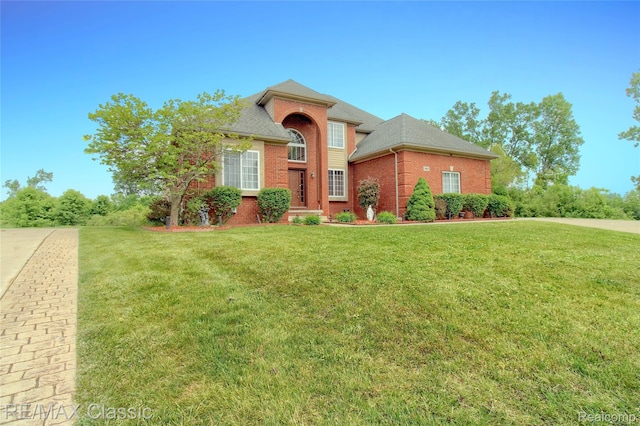 761 Nissen Ct, Wixom, MI 48393 - traditional-style home with brick siding and a front lawn