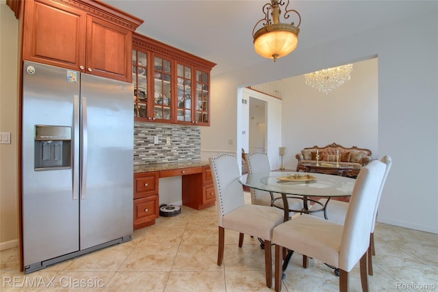 761 Nissen Ct, Wixom, MI 48393 - dining space with a chandelier, light tile patterned flooring, and built in study area