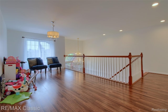 761 Nissen Ct, Wixom, MI 48393 - sitting room with a chandelier, wood finished floors, an upstairs landing, and recessed lighting