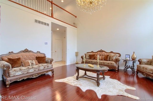 761 Nissen Ct, Wixom, MI 48393 - living area with a high ceiling, wood finished floors, and a chandelier