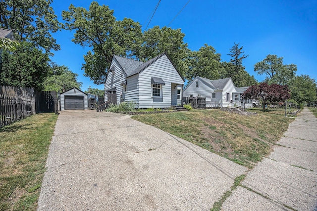 237 Holly St, Wyoming, MI 49548 - view of front of home featuring driveway, an outbuilding, and a garage