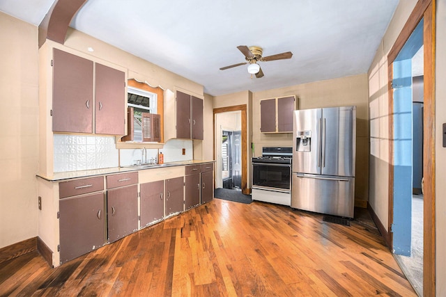 237 Holly St, Wyoming, MI 49548 - kitchen featuring stainless steel fridge with ice dispenser, gas range, a ceiling fan, wood finished floors, and light countertops