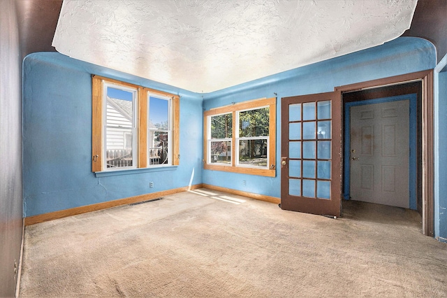 237 Holly St, Wyoming, MI 49548 - carpeted spare room featuring baseboards and a textured ceiling
