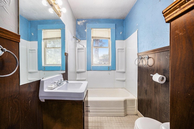 237 Holly St, Wyoming, MI 49548 - bathroom with vanity, a wainscoted wall, shower / bath combination, and tile patterned flooring