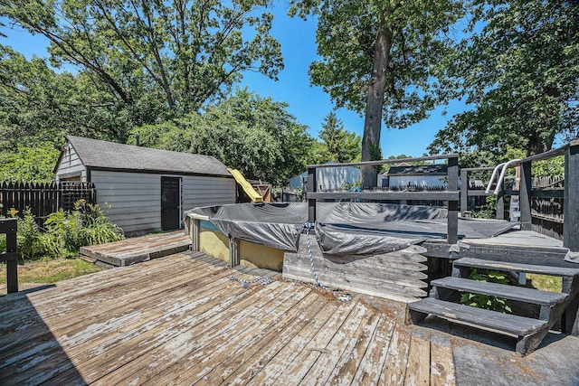 237 Holly St, Wyoming, MI 49548 - wooden deck with a jacuzzi and an outbuilding