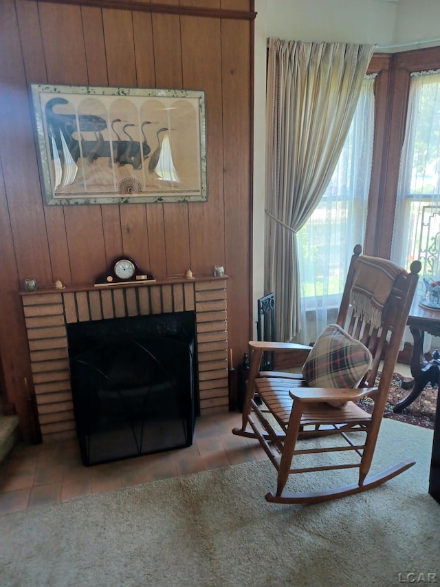 526 Comstock St, Adrian, MI 49221 - sitting room featuring tile patterned floors, a fireplace, and wood walls
