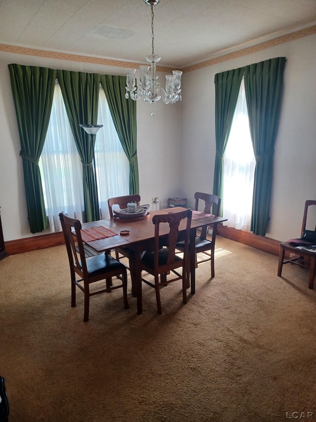 526 Comstock St, Adrian, MI 49221 - carpeted dining area featuring plenty of natural light, a chandelier, and ornamental molding