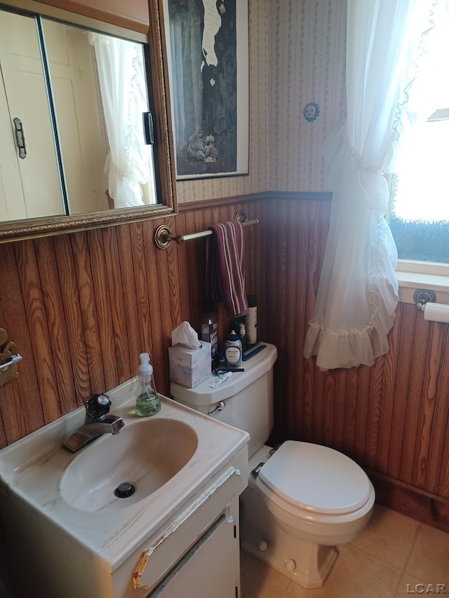 526 Comstock St, Adrian, MI 49221 - bathroom featuring wallpapered walls, vanity, a wainscoted wall, and tile patterned flooring
