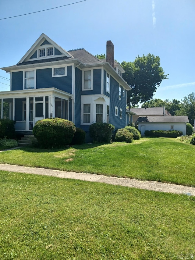 526 Comstock St, Adrian, MI 49221 - american foursquare style home featuring a chimney and a front lawn