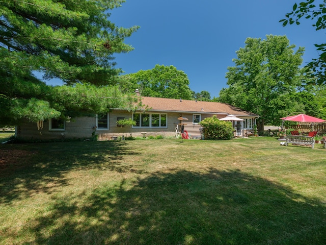 2805 Winchell Ave, Kalamazoo, MI 49008 - rear view of house with a lawn and a chimney