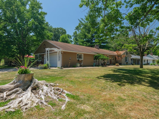 2805 Winchell Ave, Kalamazoo, MI 49008 - view of side of property featuring a garage, a lawn, and a chimney
