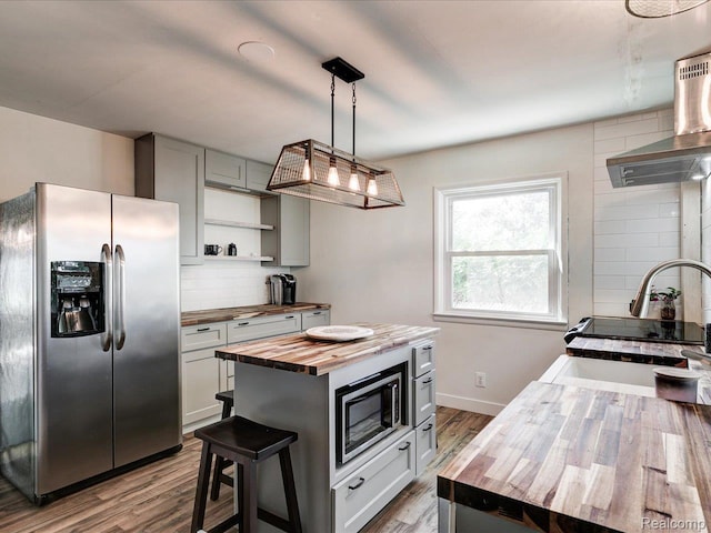 3107 Stone St, Port Huron, MI 48060 - kitchen featuring wood counters, appliances with stainless steel finishes, backsplash, open shelves, and wood finished floors
