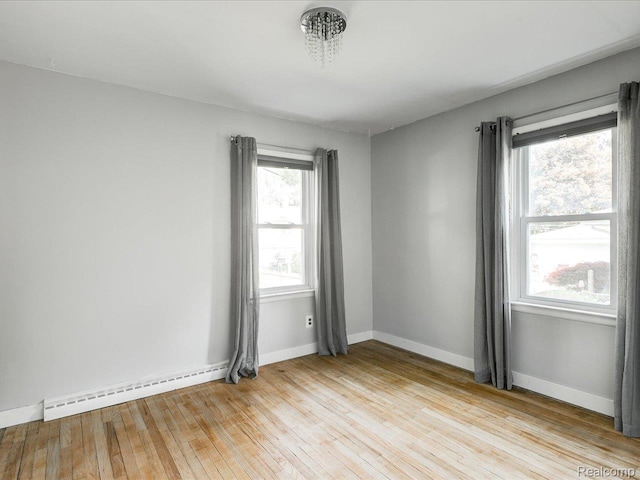 3107 Stone St, Port Huron, MI 48060 - spare room featuring a baseboard radiator and light wood-style flooring