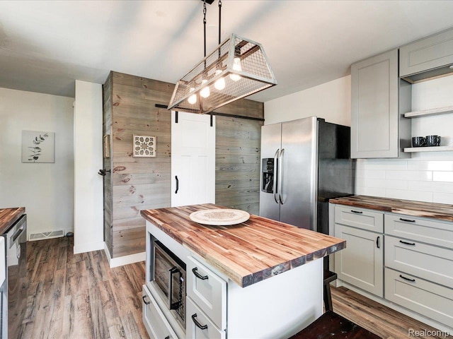 3107 Stone St, Port Huron, MI 48060 - kitchen featuring wooden counters, open shelves, decorative backsplash, dark wood finished floors, and a kitchen island
