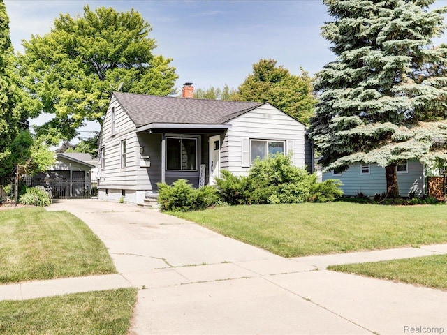 3107 Stone St, Port Huron, MI 48060 - bungalow-style house with a chimney, a front yard, roof with shingles, and concrete driveway