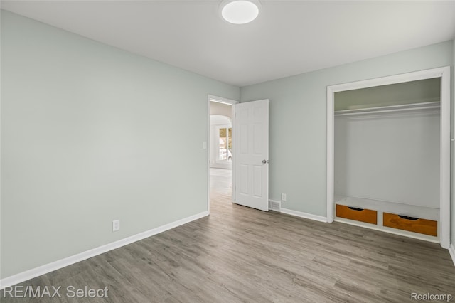 1413 Martha Ave, Burton, MI 48509 - unfurnished bedroom with wood finished floors and a closet